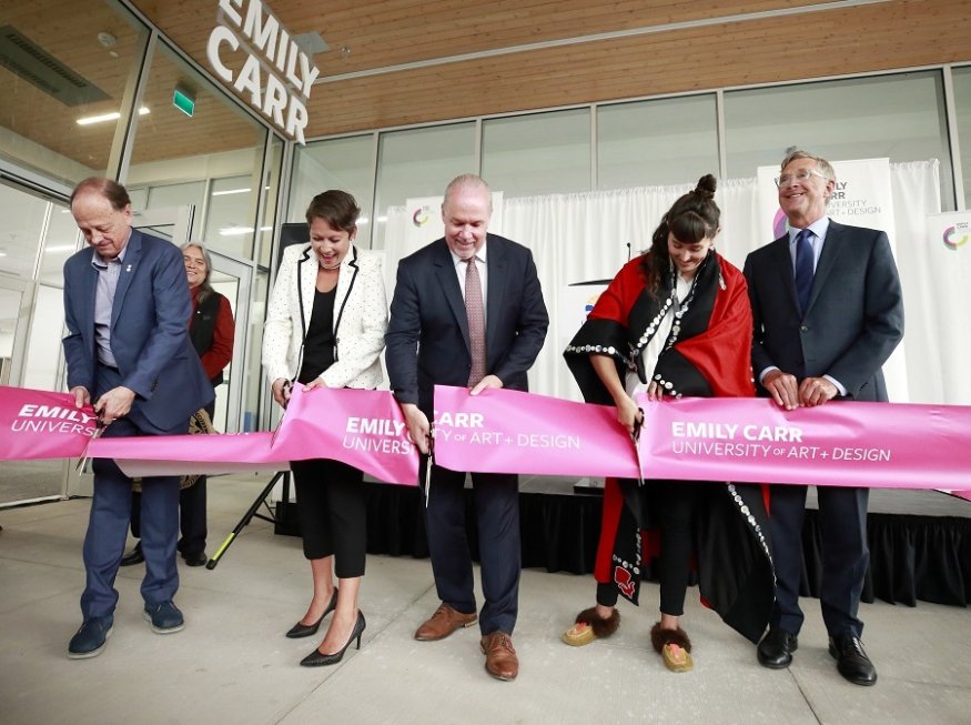 Ron Burnett, president  of Emily Carr University of Art and Design, at far left, helps Melanie Mark, the B.C. minister of advanced education, B.C. Premier John Horgan