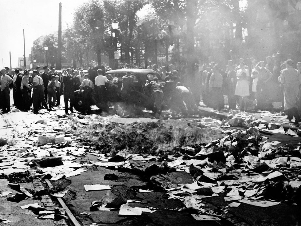 The Daily Province attempts to dispatch newspapers on trucks in 1946 when striking workers overturn vehicles and throw newspapers into the street, where they catch fire from a passing streetcar spark. Photo Vancouver Sun.