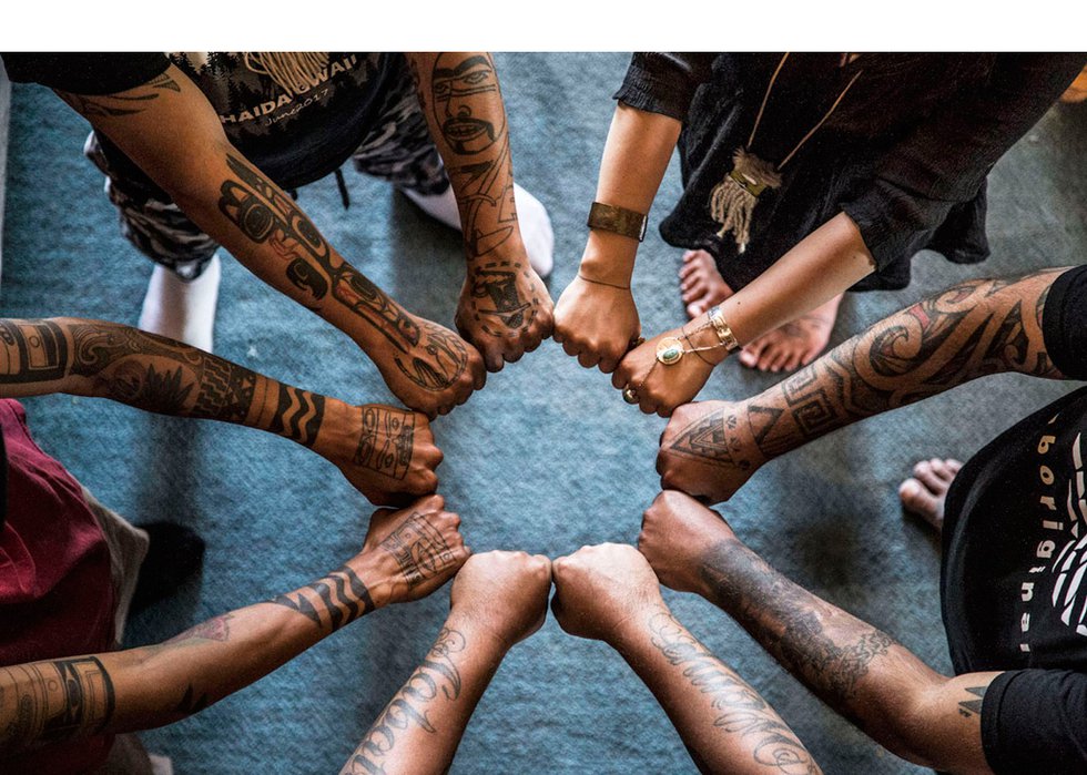 Artists in "Body Language: Reawakening Cultural Tattooing of the Northwest" show their tattoos. (photo by Aaron Leonen)