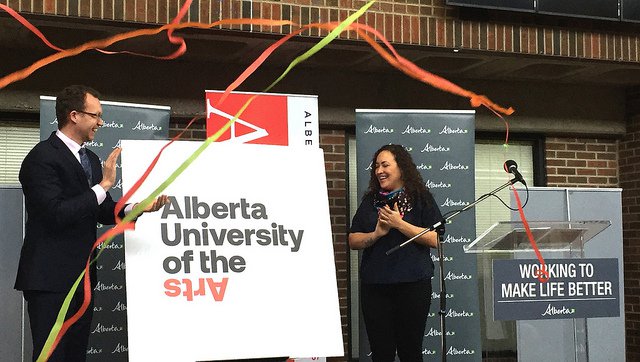 Minister Schmidt and Simone Saunders, student association director of leadership and governance at ACAD, unveil the new name and logo for the Alberta University of the Arts. (photo courtesy of The Government of Alberta)