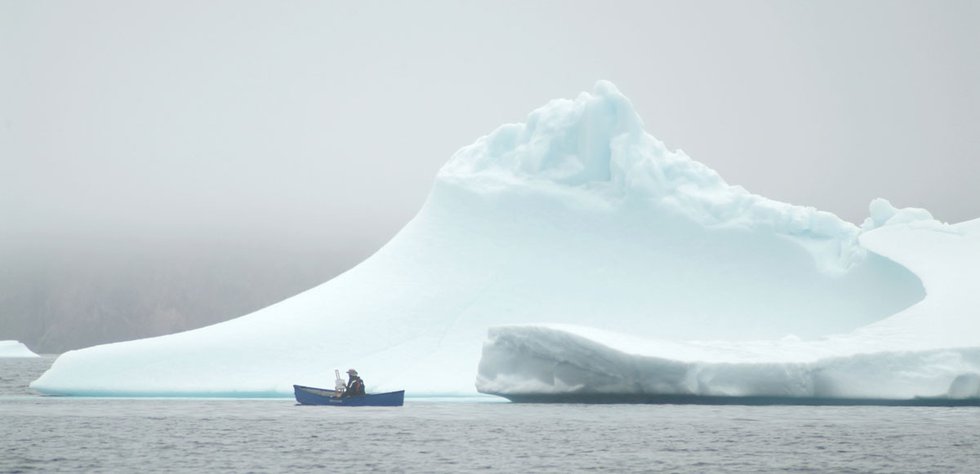 Cory Trépanier paints while floating in a portable canoe near Qikiqtarjuaq, Baffin Island, Nunavut (photo courtesy Cory Trépanier)