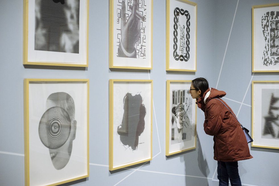 A visitor takes a closer look at "Chris Cran: At Play," an exhibition in the Glenbow’s One New Work series. (photo by Elyse Bouvier)