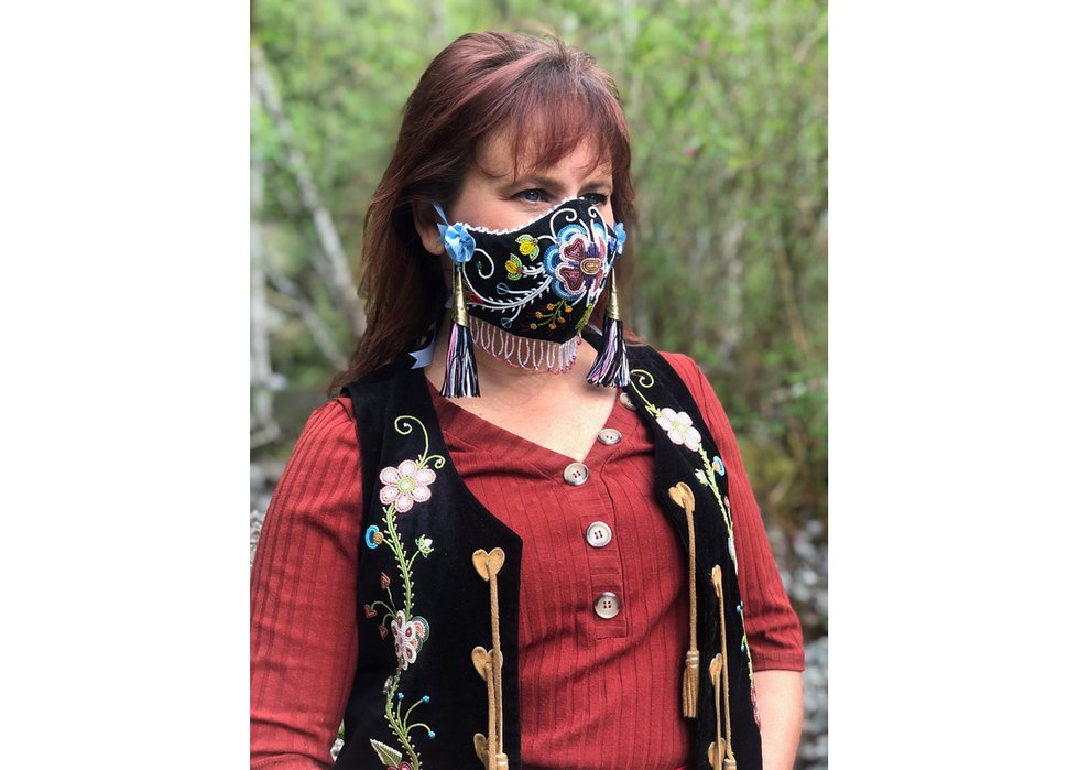 Lisa Shepherd wears her mask “Wâhkôhtowin,” a Cree word that embodies relationship not just to family but to everything, including plants, animals, the earth and the sky. (photo by Martin Shepherd)