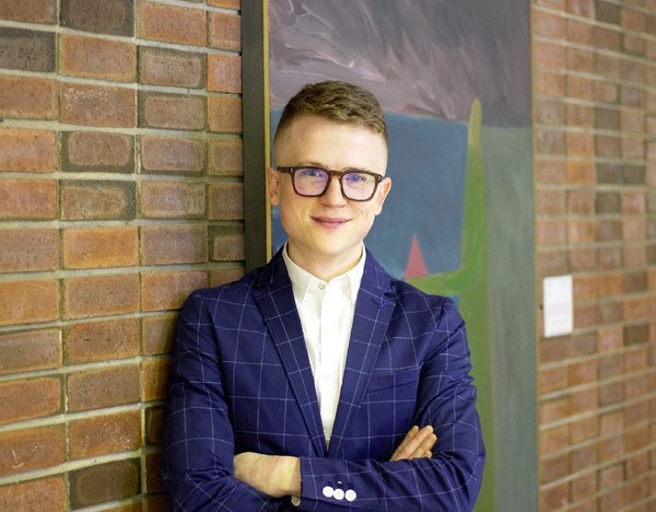 Tyler Sherard poses with “The Logician,” a 1984 oil on canvas by Edmonton artist Hudson Wong. (courtesy McMullen Gallery, Edmonton)