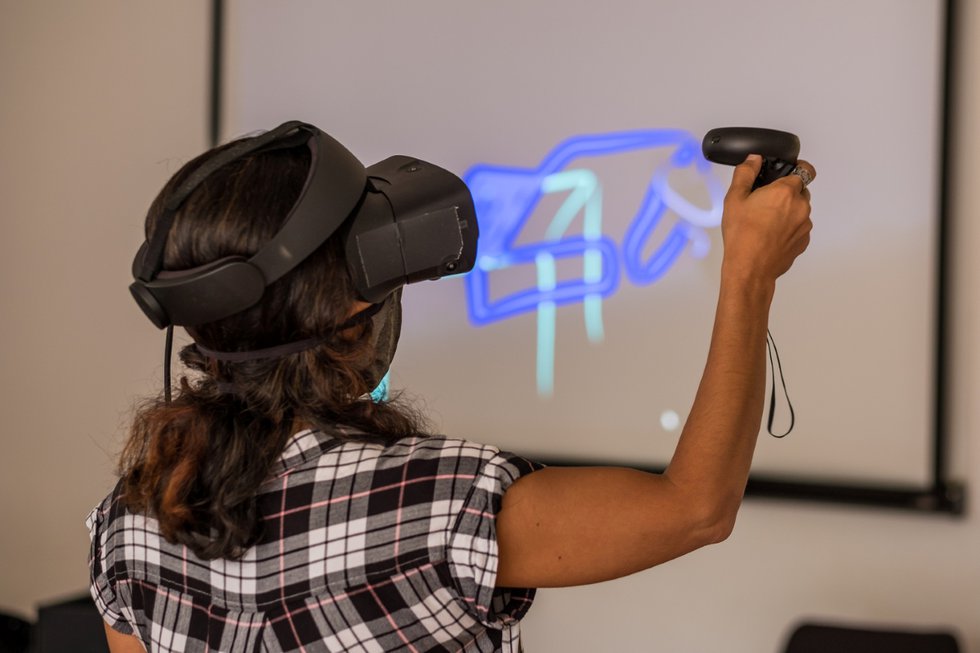 Aitak Sorahitalab, an artist with a Master's degree from the Art University of Tehran, learns about augmented reality at a recent workshop that was part of Arts Etobicoke's mural project in Islington Village. (photo by Jeremy Sale)