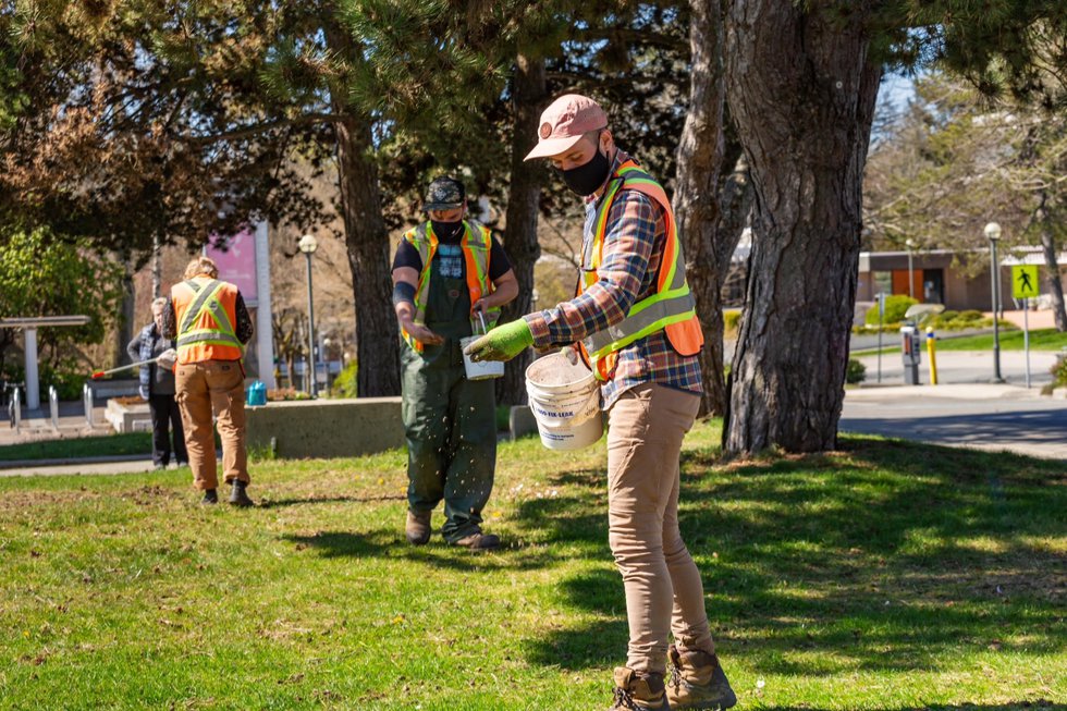 Students spreading seed for "Fireweed Fields," 2021 (photo by Nigel Laing; courtesy Morris and Helen Belkin Gallery, Vancouver)