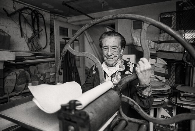 Louise Bourgeois at the printing press in the lower level of her home and studio on 20th Street