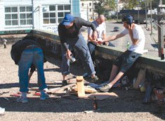 "Members of rebel collective "26" prepare "prefabs" for street installations known as nailbombings."