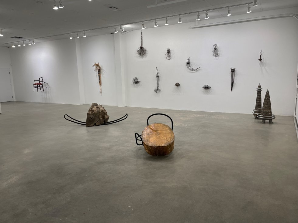 Installation view of work by Walter May (foreground), Katie Ohe (right wall), Ron Kanashiro (middle wall) and Laura Vickerson (left wall) in “Shaping Calgary,” 2021