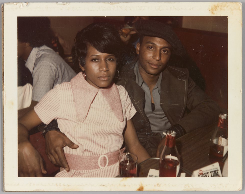 Unknown photographer, “[Man and woman sitting at table, his arm around her waist],” 1963-1970