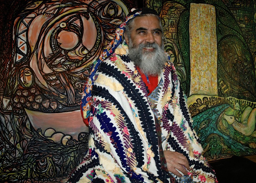 Syrian artist Aboud Salman poses with some of his work in Edmonton. (photo by Agnieszka Matejko)