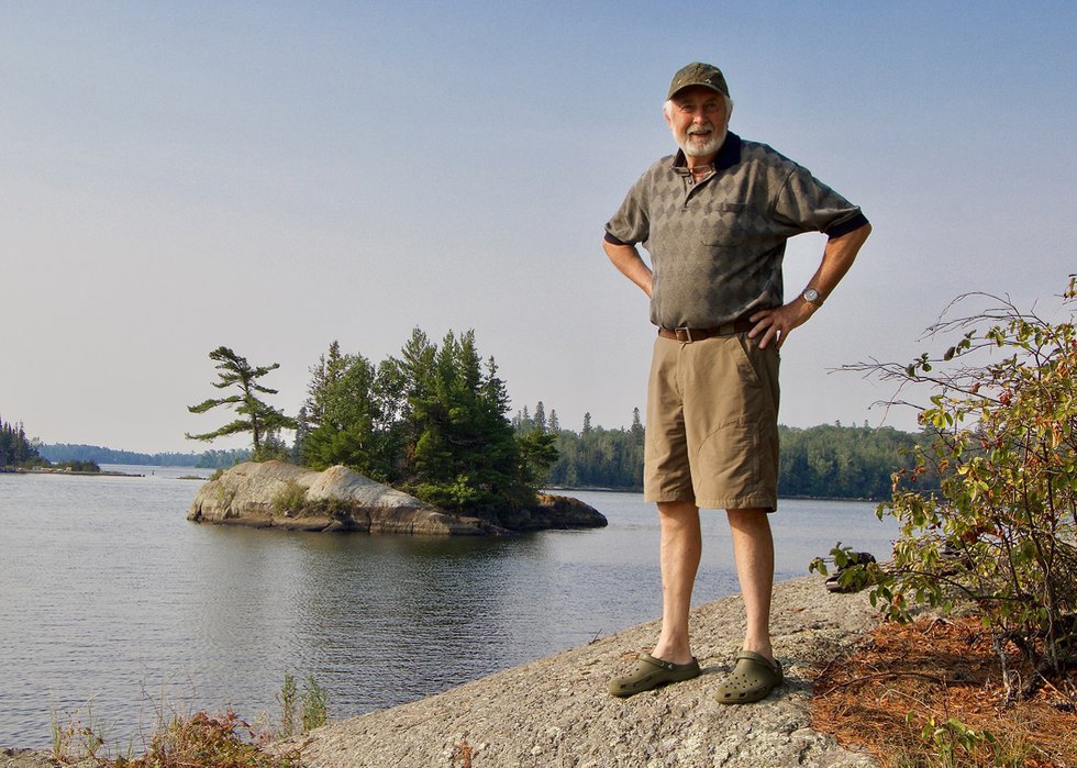 Bill Mayberry stands across the inlet from the island he believes was in Walter J. Philips’ 1928 woodblock print, “Sunset, Lake of the Woods.” (courtesy Randolph Parker)