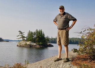 Bill Mayberry stands across the inlet from the island he believes was in Walter J. Philips’ 1928 woodblock print, “Sunset, Lake of the Woods.” (courtesy Randolph Parker)