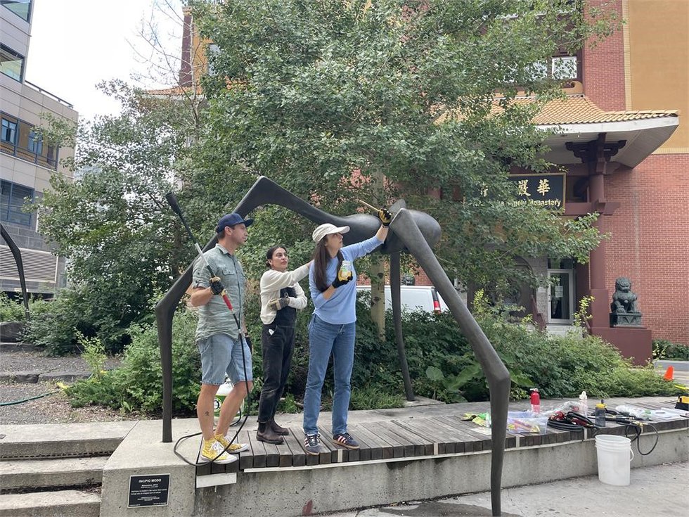 Edmonton Public Art conservators Mitra Saeedi and David Simmonds join Calgary Public Art’s Elisa Contreras Cigales in the maintenance of Ascension (photo courtesy of City of Calgary)