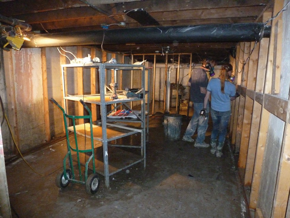 "After the Calgary flood, Stride’s volunteers set documents and other material out to dry as other volunteers worked to repair basement walls"