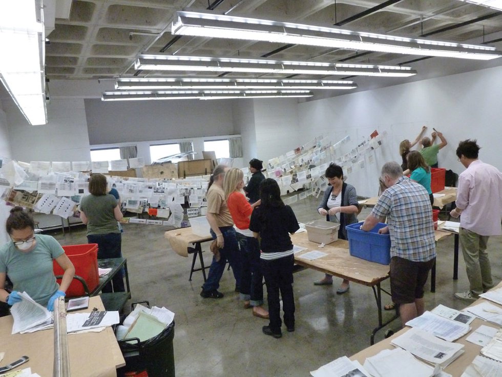 "After the Calgary flood, Stride’s volunteers set documents and other material out to dry as other volunteers worked to repair basement walls"