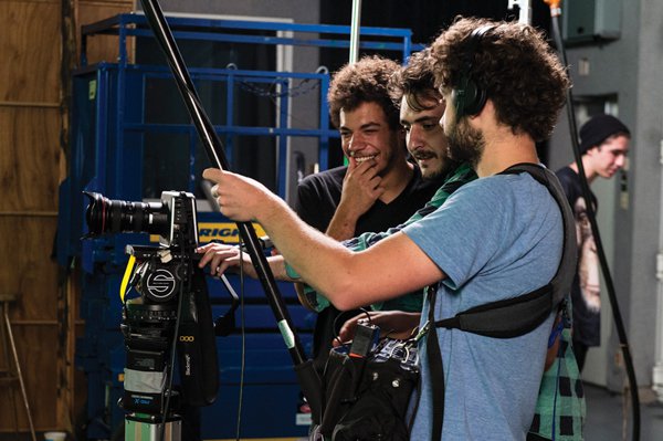 Neïl Beloufa (centre) and his team