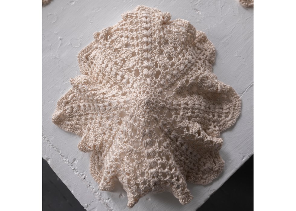 Lucas Morneau, “Goalie Doilies,” 2021, cotton yarn, plaster of paris, crochet and plaster casting, 9.4" x 7.9" x 3" (photo by The Reach Gallery)