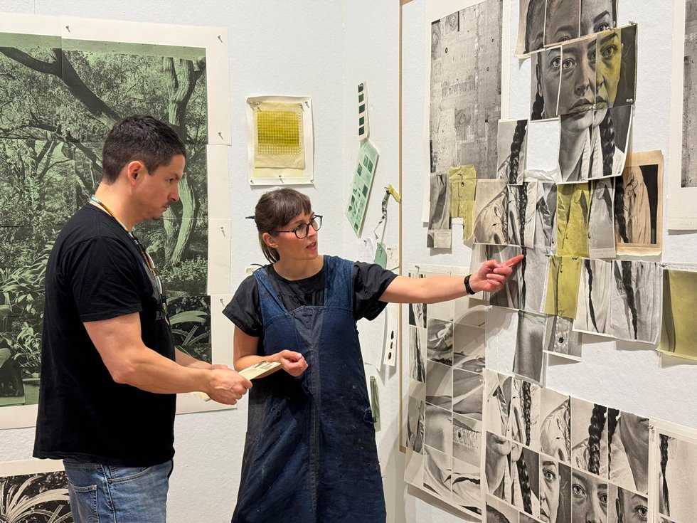 Wally Dion, left, and Jillian Ross discuss different types of paper during the Live Editions/Jillian Ross Print residency at the Remai Modern in Saskatoon, Sask. (photo by Nasibeh Nasibi)